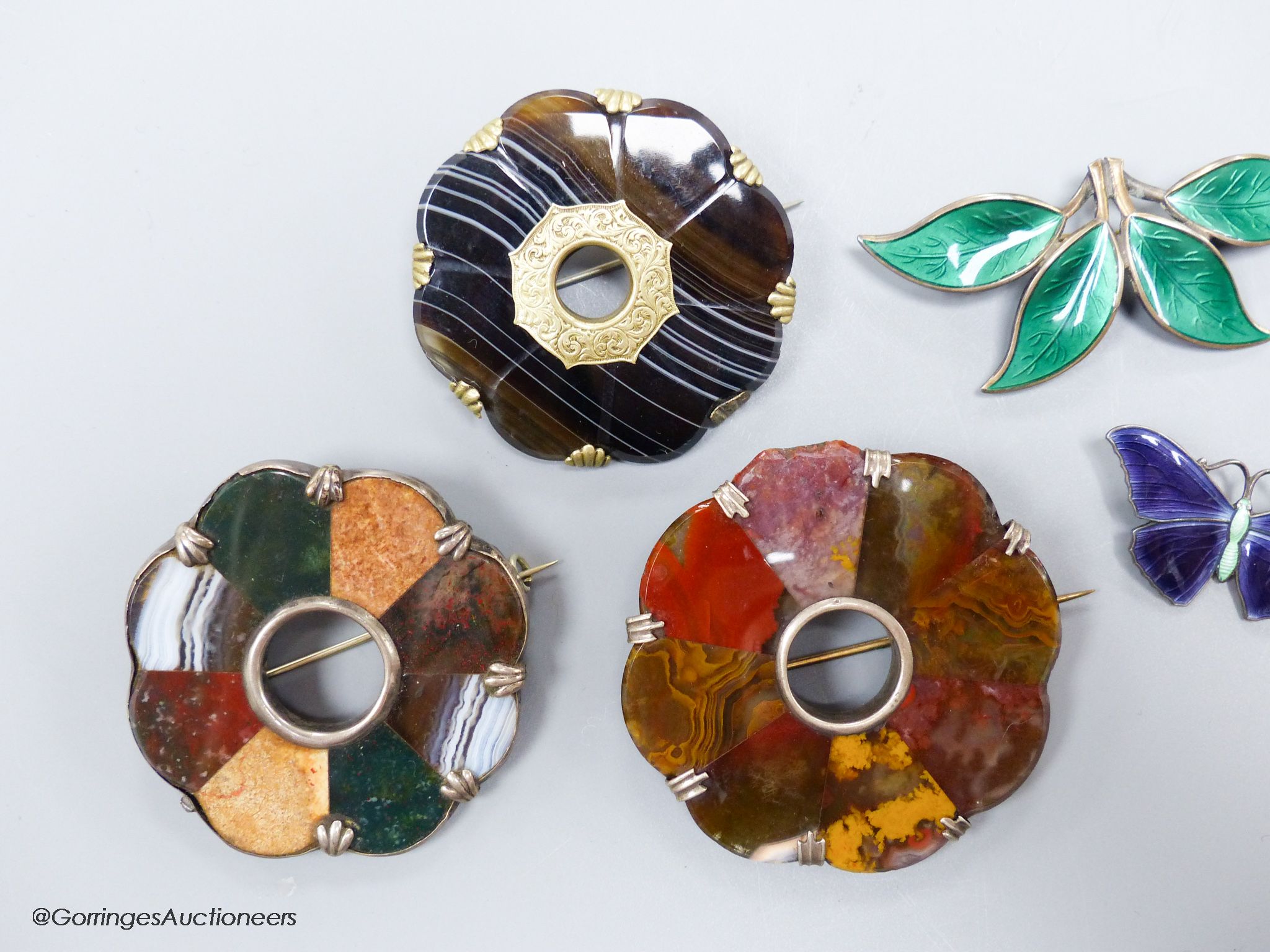 Two sterling and enamel brooches, including butterfly, 37mm, one other white metal brooch and three hardstone set brooches.